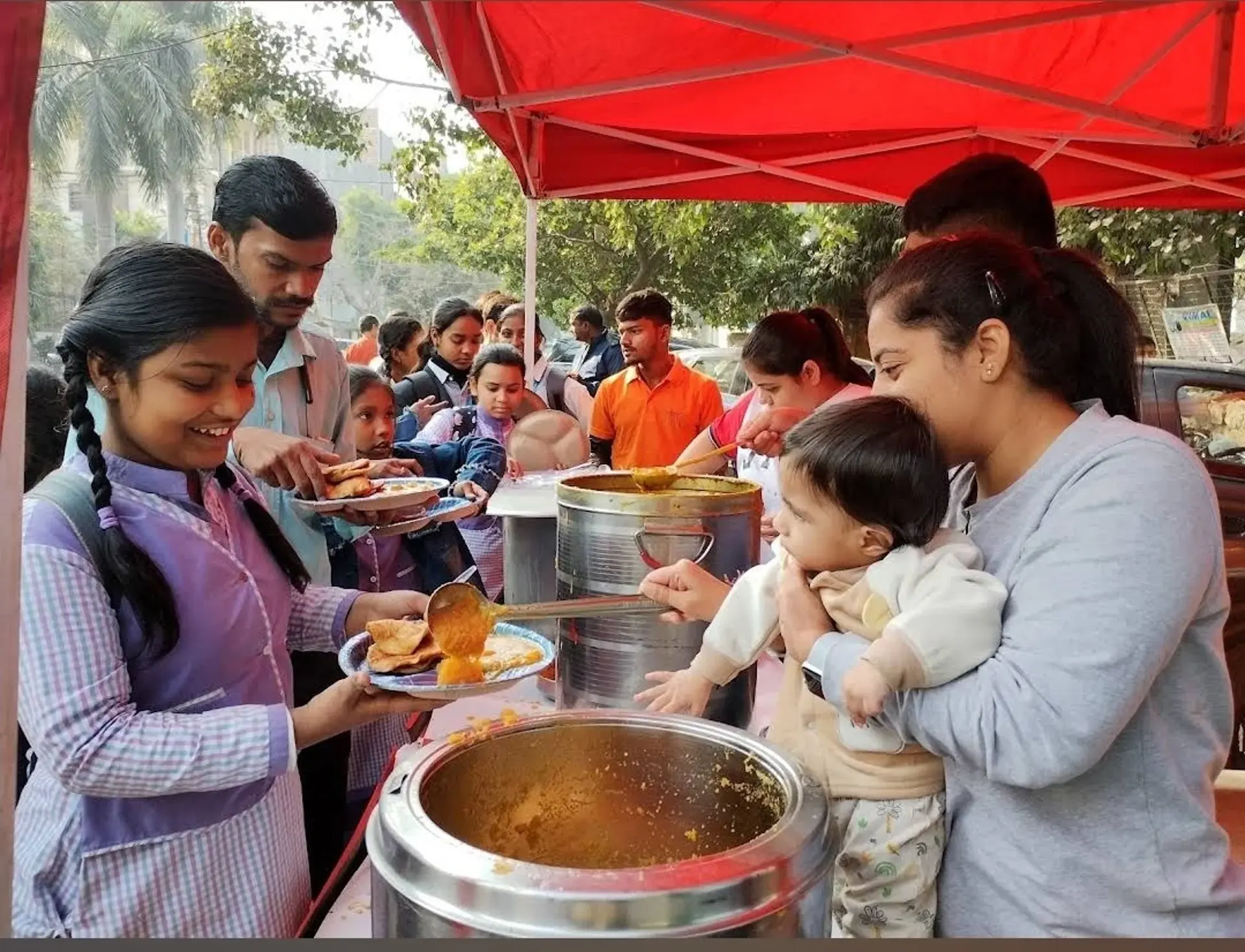 Volunteers serving hot meals during a community food distribution
