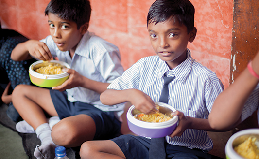 Volunteers serving hot meals during a community food distribution